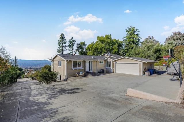 ranch-style house featuring a garage and a mountain view