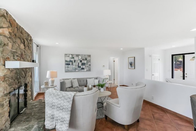 living room featuring a fireplace and dark tile patterned flooring