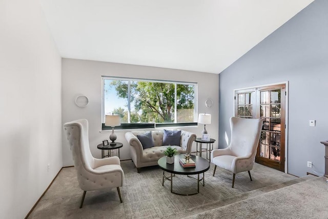 carpeted living room featuring vaulted ceiling