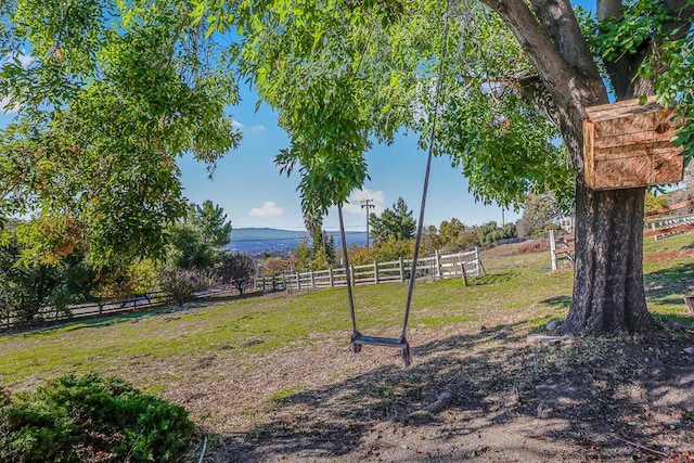 view of yard with a rural view and a mountain view