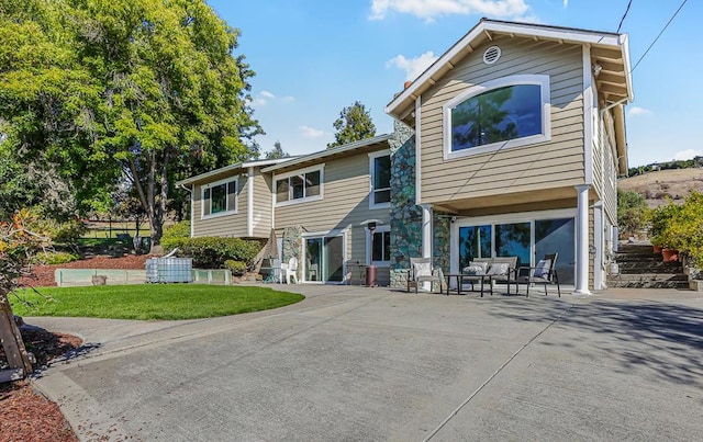 view of front of property with a garage, outdoor lounge area, and a front lawn