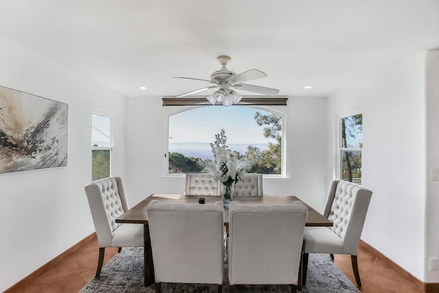 tiled dining area featuring ceiling fan