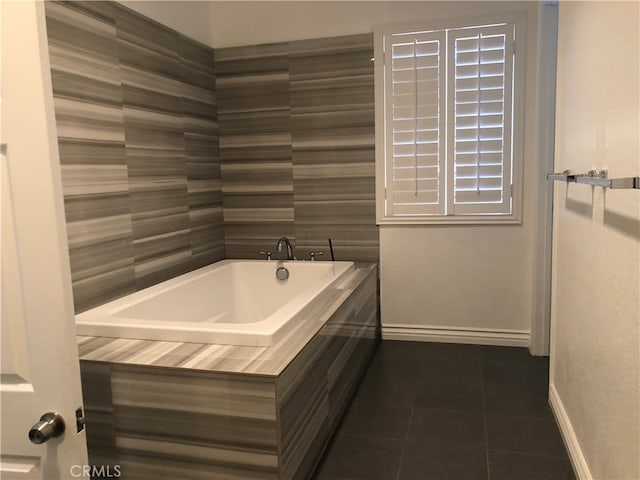 bathroom featuring tile patterned flooring and tiled bath