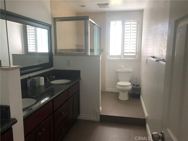 bathroom featuring walk in shower, tile patterned flooring, vanity, and toilet