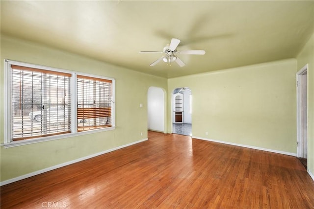 empty room with hardwood / wood-style flooring and ceiling fan