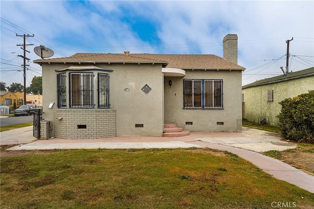 rear view of property featuring a yard