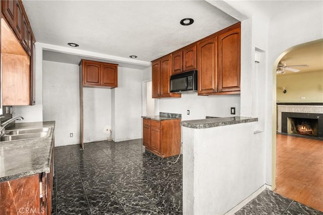 kitchen featuring dark hardwood / wood-style floors, ceiling fan, and sink