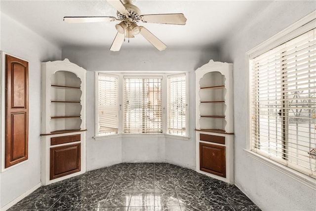 unfurnished dining area featuring plenty of natural light and ceiling fan