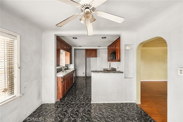 kitchen featuring dark hardwood / wood-style flooring, ceiling fan, and sink