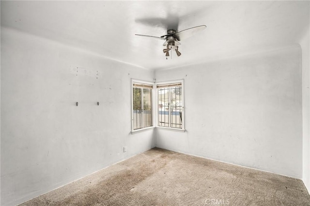 empty room featuring carpet floors and ceiling fan