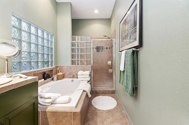 bathroom with tile patterned floors, vanity, and plus walk in shower