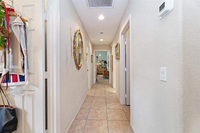 hall with light tile patterned floors