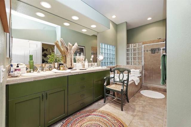 bathroom with tile patterned flooring, vanity, and a shower with door