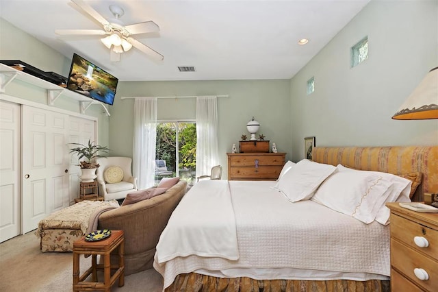 carpeted bedroom featuring ceiling fan and a closet