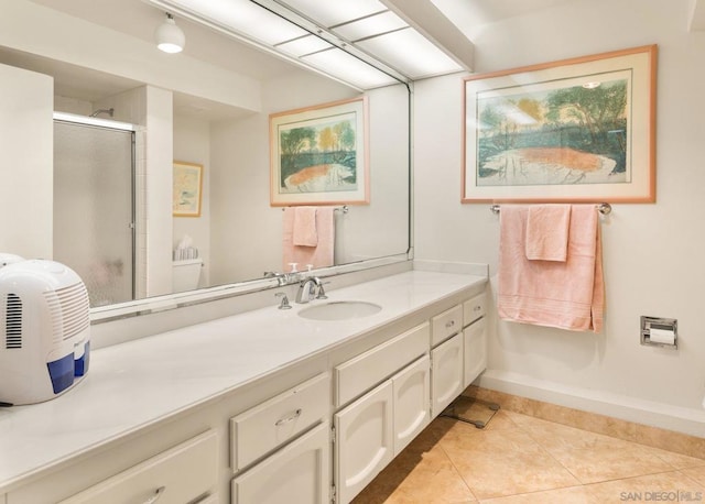 bathroom featuring tile patterned flooring, vanity, and walk in shower