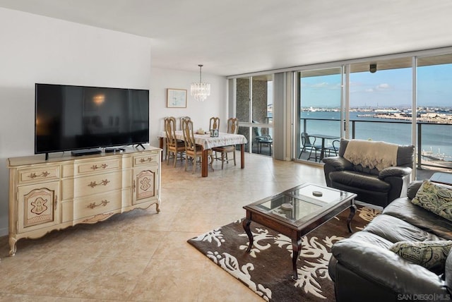 tiled living room with a water view, an inviting chandelier, and expansive windows