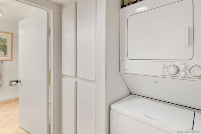 laundry room featuring stacked washer / drying machine