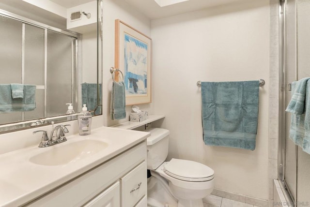 bathroom featuring tile patterned flooring, vanity, and toilet