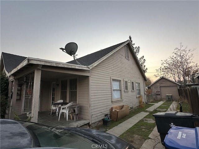 back house at dusk featuring a patio area