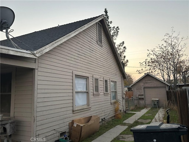 property exterior at dusk with a storage unit