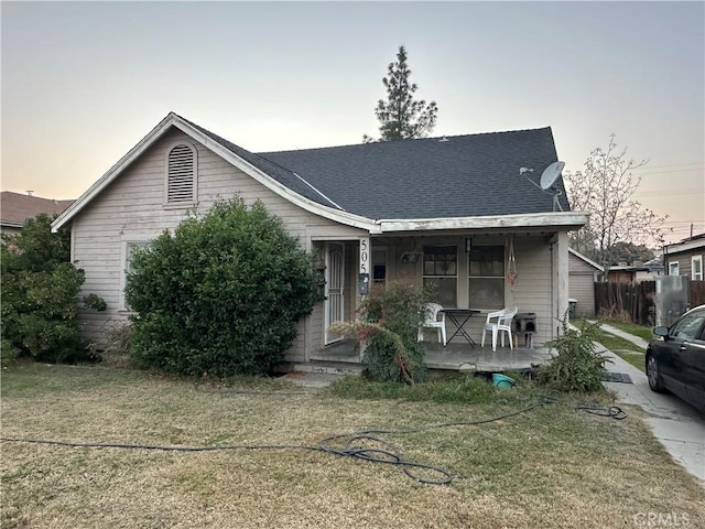 view of front of property featuring a yard and covered porch