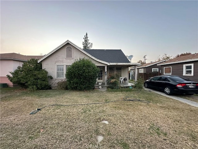 view of front of property with a porch and a yard