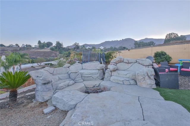 exterior space featuring a mountain view and a trampoline