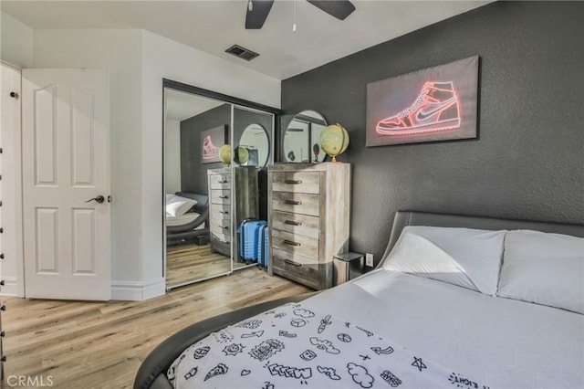 bedroom featuring ceiling fan, a closet, and hardwood / wood-style floors