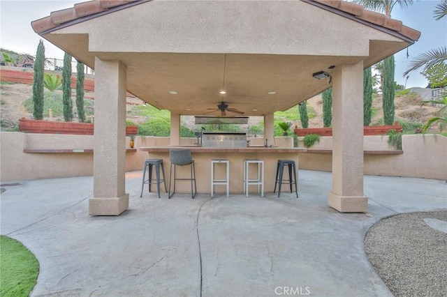 view of patio featuring ceiling fan and a bar