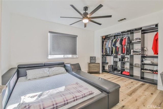 bedroom with ceiling fan, hardwood / wood-style floors, and a closet