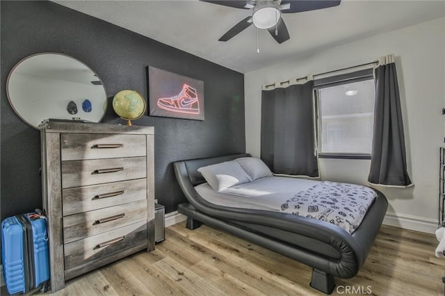 bedroom with ceiling fan and hardwood / wood-style floors