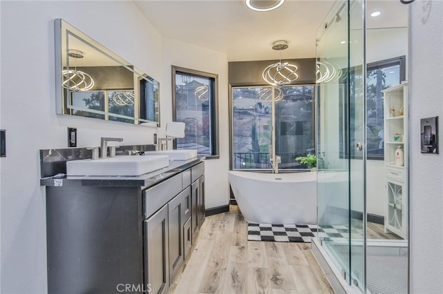 bathroom featuring separate shower and tub, vanity, a notable chandelier, and hardwood / wood-style floors