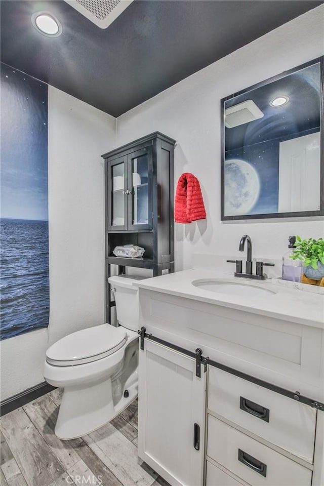 bathroom featuring toilet, vanity, and a water view