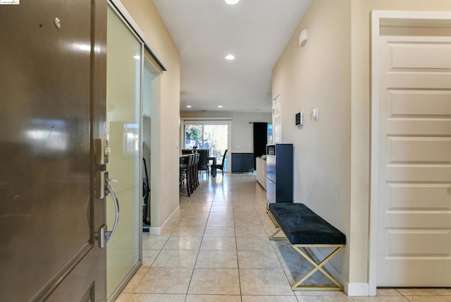 hall featuring light tile patterned flooring