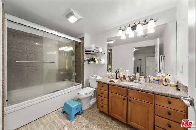 full bathroom featuring vanity, toilet, and combined bath / shower with glass door