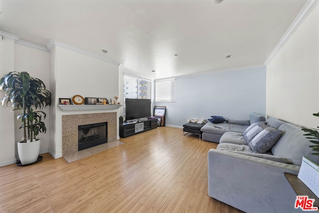 living room with crown molding and light hardwood / wood-style floors