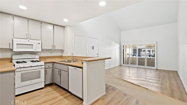 kitchen featuring white appliances, sink, and light hardwood / wood-style flooring