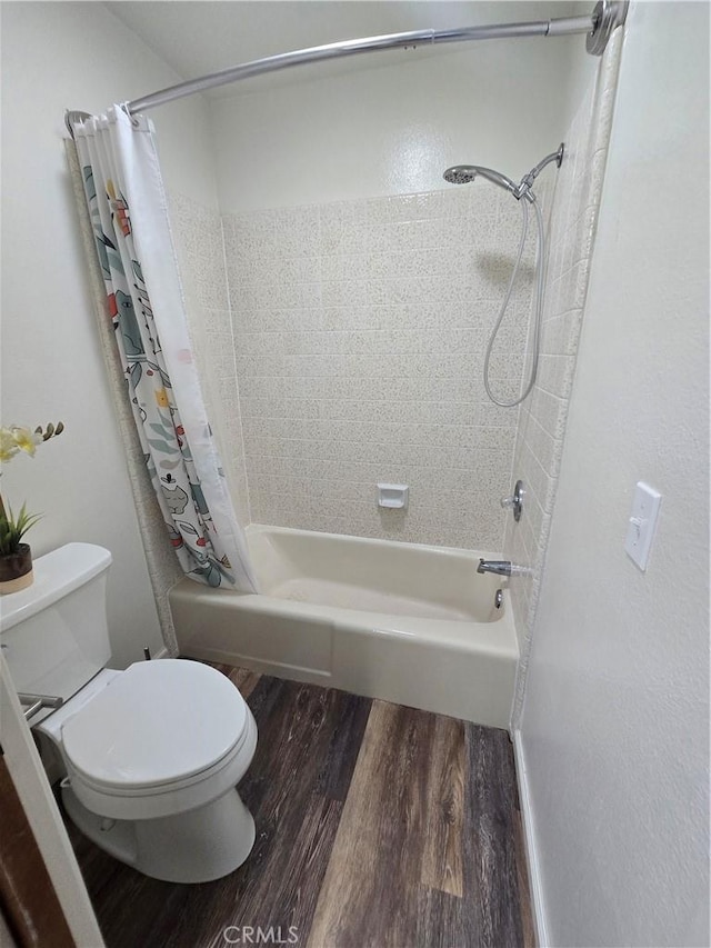 bathroom with toilet, hardwood / wood-style flooring, and shower / bath combo with shower curtain