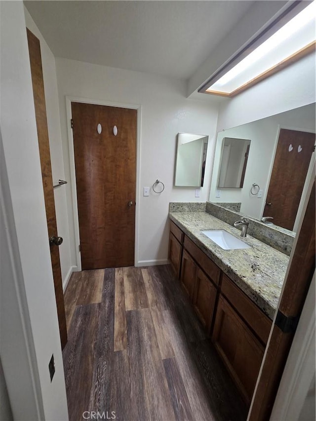 bathroom featuring vanity and wood-type flooring