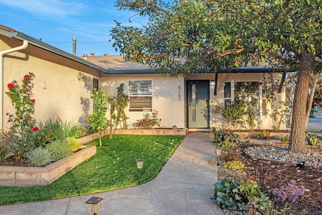 doorway to property featuring a yard