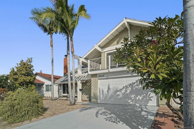 view of front of house featuring a balcony and a garage