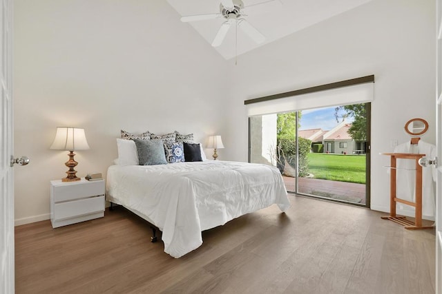 bedroom featuring access to exterior, ceiling fan, hardwood / wood-style floors, and high vaulted ceiling