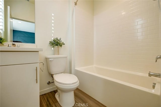 full bathroom featuring hardwood / wood-style floors, vanity, shower / bath combination, and toilet