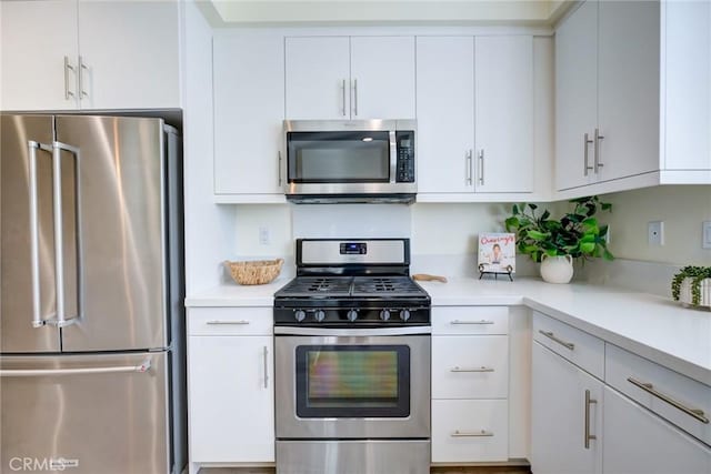 kitchen with white cabinets and appliances with stainless steel finishes