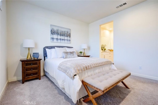 carpeted bedroom with ensuite bathroom