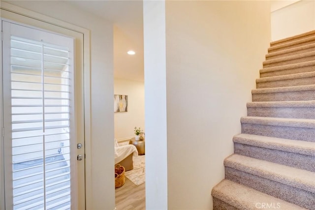 stairway featuring wood-type flooring