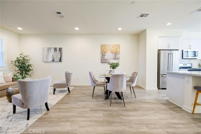 dining room with light hardwood / wood-style floors