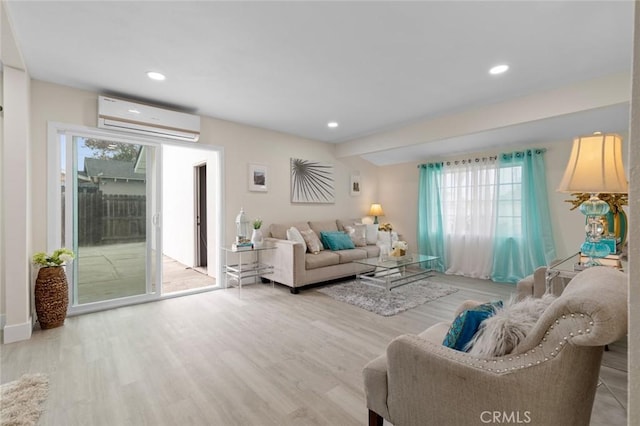 living room featuring a wall mounted air conditioner and hardwood / wood-style flooring