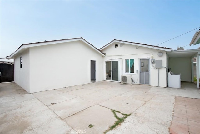 back of house featuring ac unit, a patio, and stucco siding