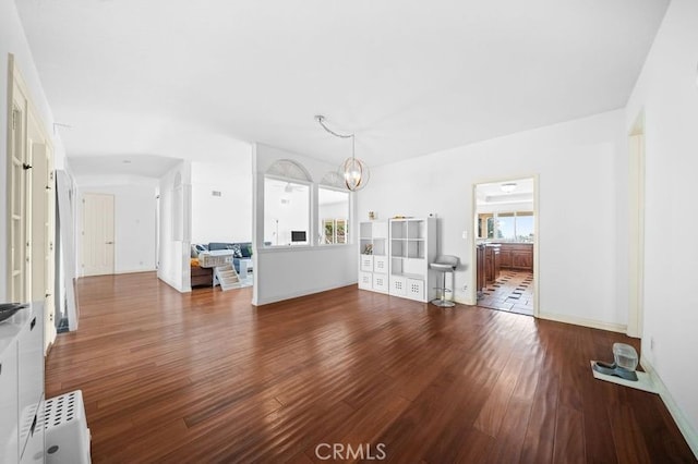 unfurnished living room with hardwood / wood-style flooring and an inviting chandelier